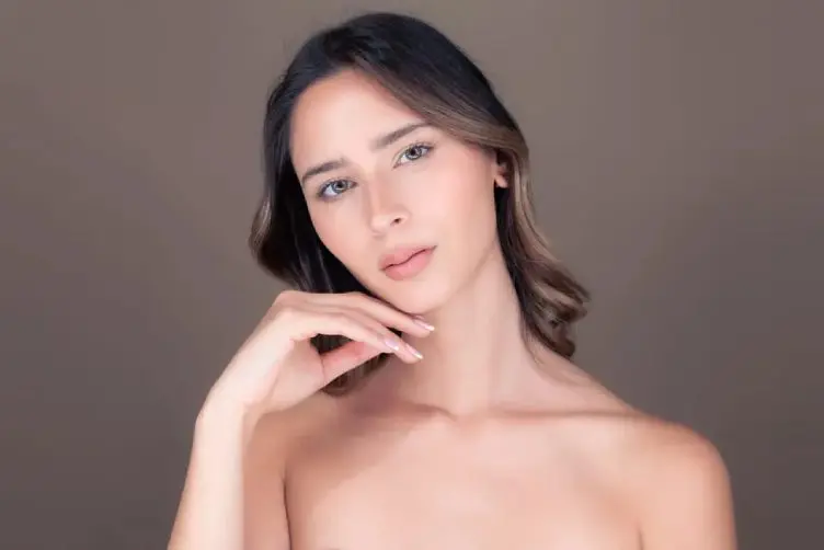 Beauty portrait of young woman touching chin
